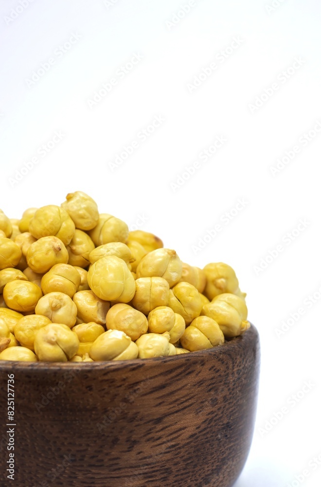 Closeup of Roasted Garbanzo Bean or Chickpea in a Wooden Bowl Isolated on White Background, Also Known as Bengal Gram or Egyptian Pea Closeup of Roasted Garbanzo Bean or Chickpea in a Wooden Bowl Isolated on White Background, Also Known as Bengal Gram or Egyptian Pea