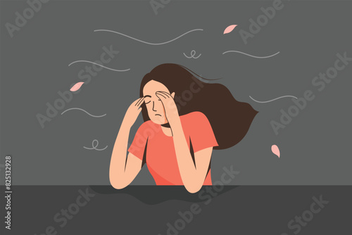 A Young woman holds her hands to her head, looking stressed and sad.