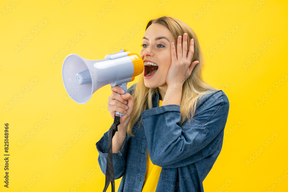 Smiling fun young woman in denim jacket posing isolated on yellow background in studi Scream in megaphone, announces discounts sale Smiling fun young woman in denim jacket posing isolated on yellow background in studi Scream in megaphone, announces discounts sale