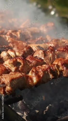 Wallpaper Mural Delicious appetizing steak meat is fried outside on fire and smoke. Shish kebab on the grill on a summer vacation in nature with friends. Barbecue grill with smoke on coals Torontodigital.ca