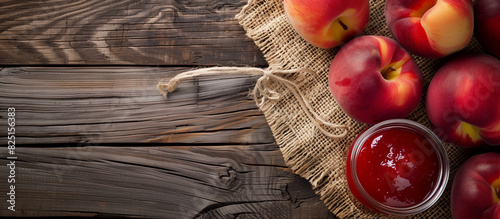 nectarine peach mash, jam on a burlap wooden background, top view. advertising of mashed nectarine peach photo