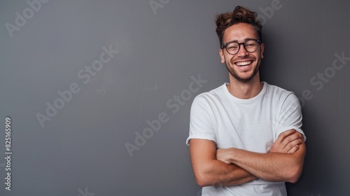 Portrait of young handsome smiling business guy wearing gray shirt and glasses, feeling confident with crossed arms, isolated on white background photo