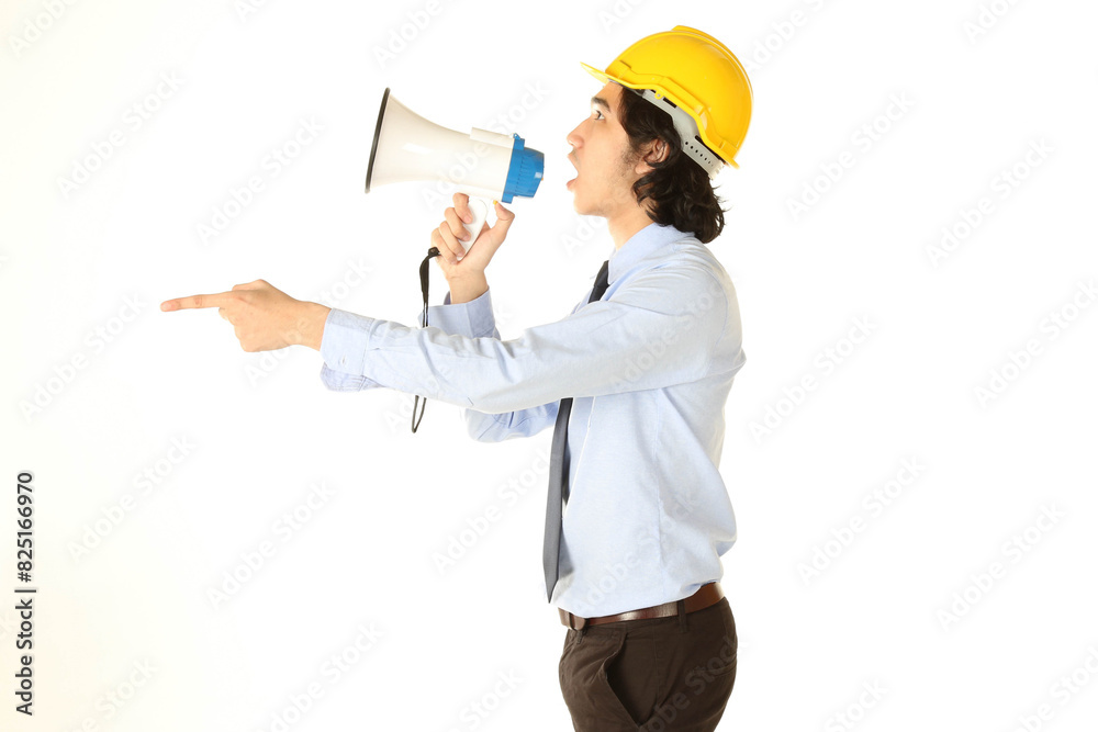 Portrait of young engineer wear yellow safety helmet hold the megaphone, over white background Portrait of young engineer wear yellow safety helmet hold the megaphone, over white background
