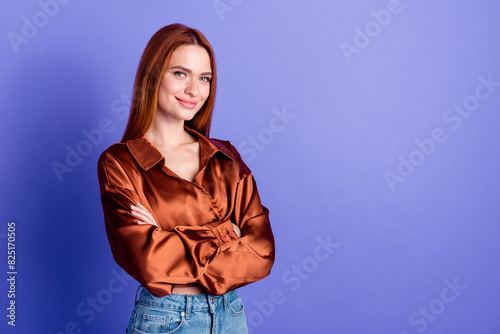 Portrait of nice young woman crossed hands empty space wear brown shirt isolated on purple color background