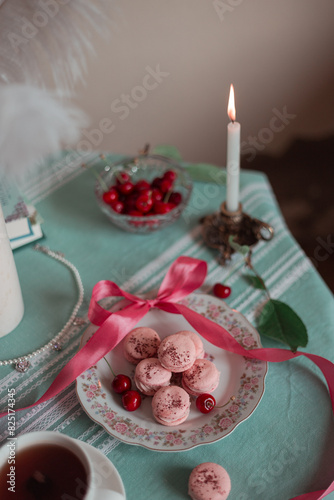 pink macarons served with cherries  photo