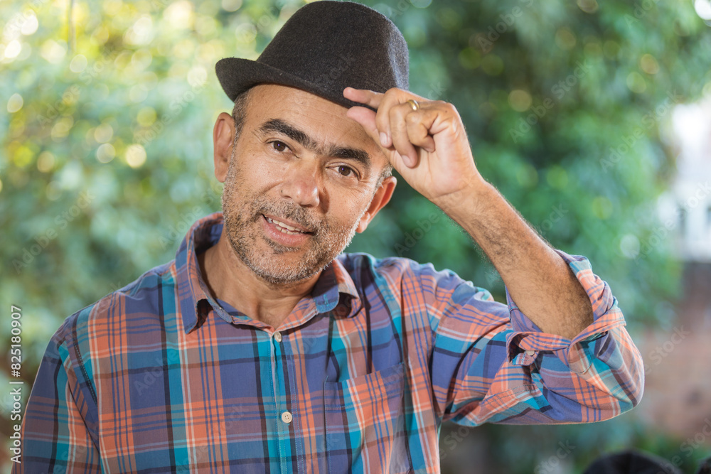 50-year-old man, wearing a black hat, gray beard, wearing prescription glasses. Mature, confident and smiling. face portrait 50-year-old man, wearing a black hat, gray beard, wearing prescription glasses. Mature, confident and smiling. face portrait