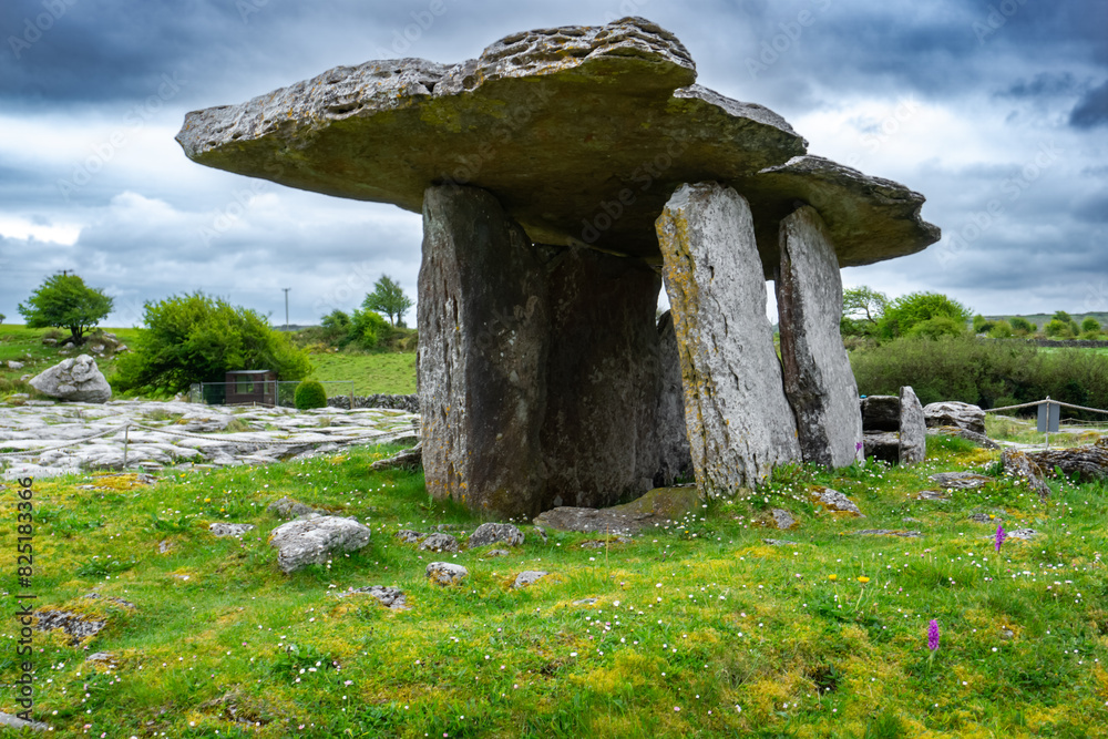 Poulnabrone dolmen in Burren geopark, Ireland, with dramatic cloud sky Poulnabrone dolmen in Burren geopark, Ireland, with dramatic cloud sky