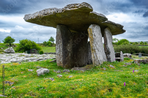 Fotografie Poulnabrone dolmen in Burren geopark, Ireland, with dramatic cloud sky