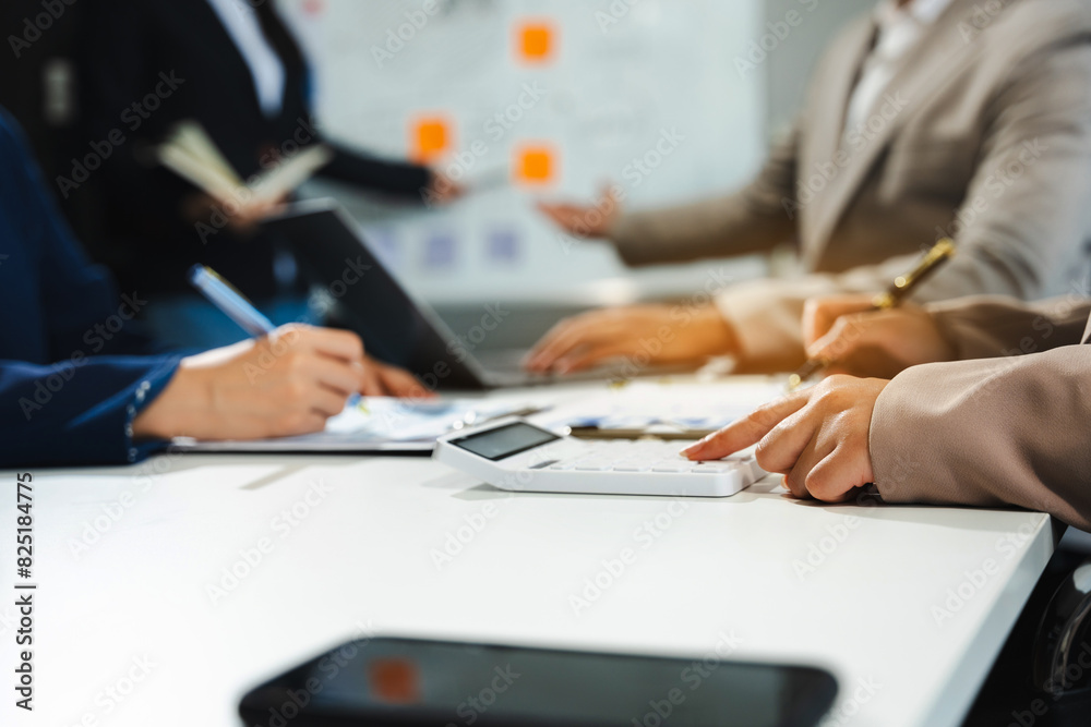 Teamwork process, Business team using a calculator to calculate the numbers of statistic business profits growth rate on documents graph data, desk in the office. Teamwork process, Business team using a calculator to calculate the numbers of statistic business profits growth rate on documents graph data, desk in the office.