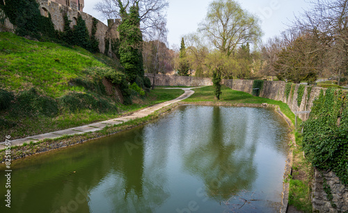 Moat of Bojnice Castle with stone walls.