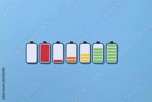 Paper-cut icons of batteries with different levels of charge on