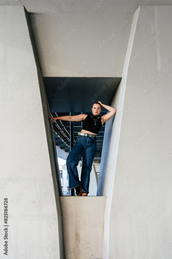 Confident woman standing on bridge pillar Confident woman standing on bridge pillar