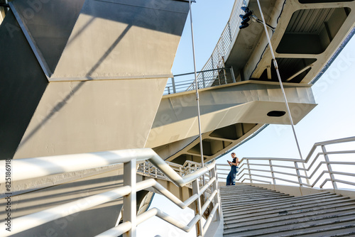 Dynamic bridge structure and stairs with person figure photo