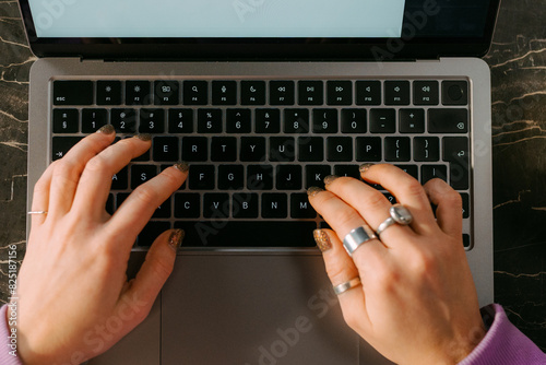 Women hands on laptop keyboard photo