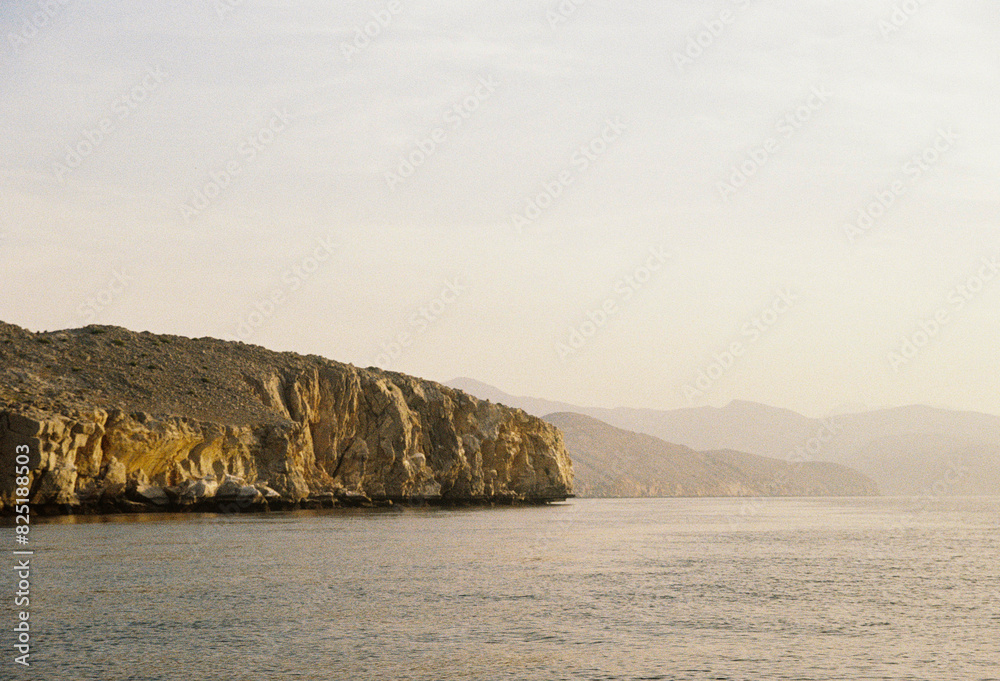 The sea with mountains of Oman during the sunset The sea with mountains of Oman during the sunset