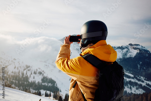 Skier photographs the mountains photo