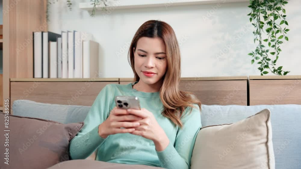 A woman using chat message app on smartphone, in response to communication. A woman using chat message app on smartphone, in response to communication.