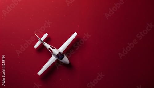 Toy EV aircraft on rich burgundy background with copy space