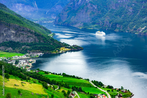 A grand cruise ship sails through Sunnylvsfjorden fjord close to the village of Geiranger in western Norway photo