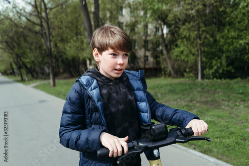 Young Boy Riding Bike Down Street photo