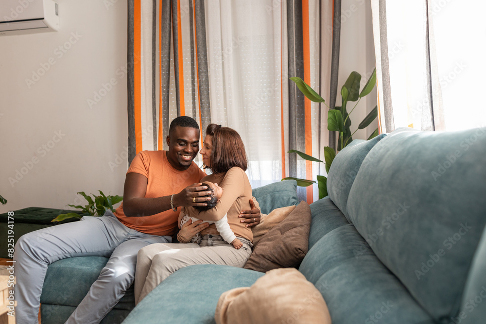 multiracial couple with baby at home multiracial couple with baby at home