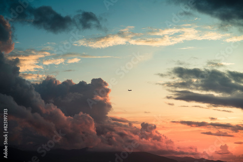 Flying plane during striking cloud sunset photo