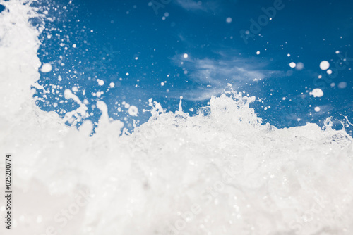 Surreal sea wave big foam texture with blue sky photo