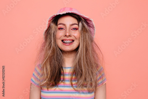 Smiling woman in casual outfit on peachy background  photo