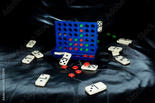 Strategic and tactic connect four game on leather sofa with flashlight photo