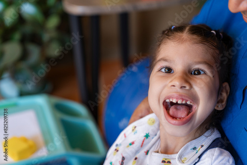 Excited girl with unrecognizable man in uniform photo