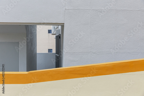 Entrance to the stairs of the gray building.