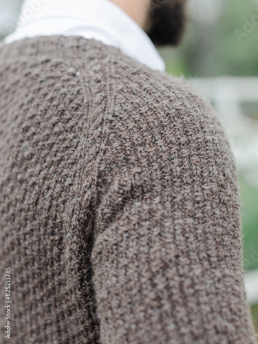 Close up of sweater knit from handspun yarn worn on a man photo