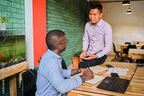 Man assisting his colleague in the office