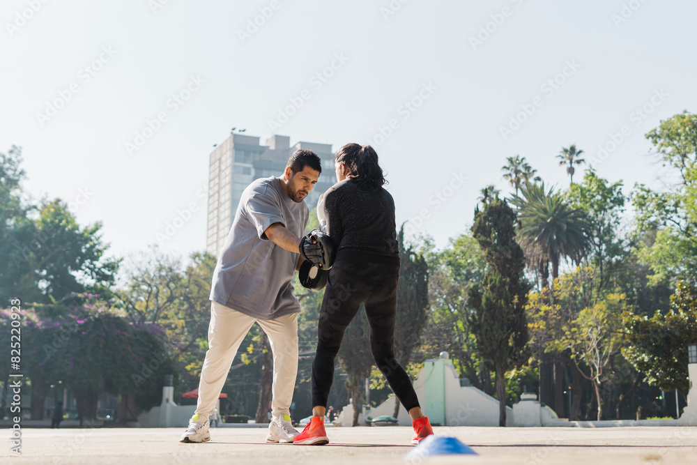 Boxing trainer working in the park. Boxing trainer working in the park.