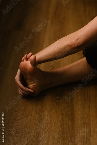 Close up of the hand and foot of an individual stretching her muscles