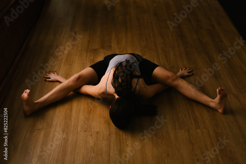 A professional yoga trainer refines her body's flexibility photo