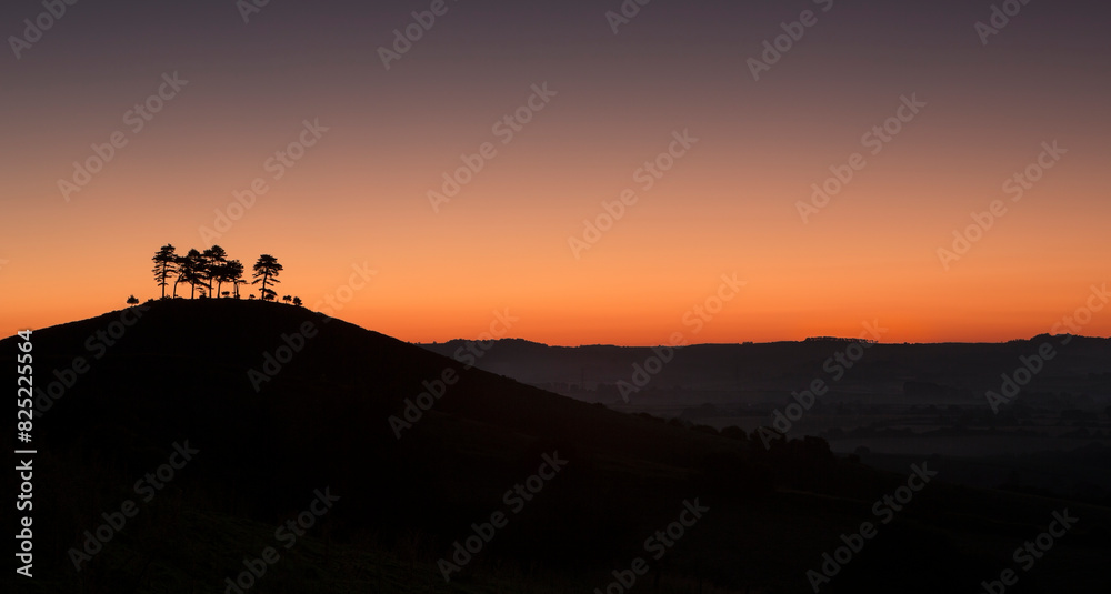 Sunrise over the hills and misty valleys of England