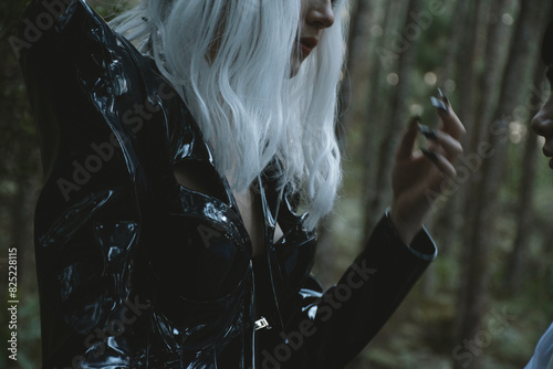 Futuristic Woman  in Black Costume  with White Wig in a Forest  Sunset photo