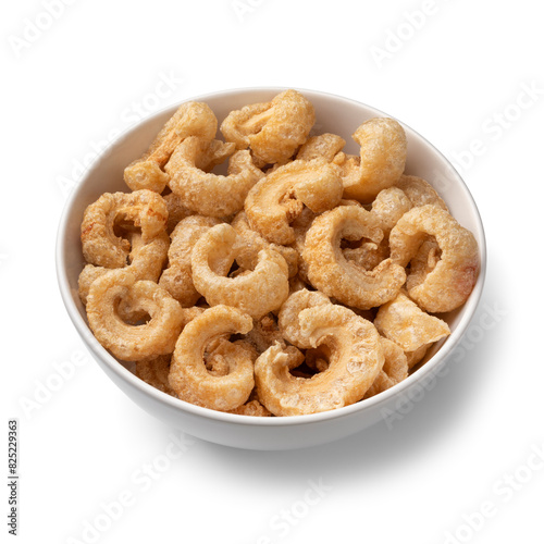 Bowl with traditional fried pork rind isolated on white background close up