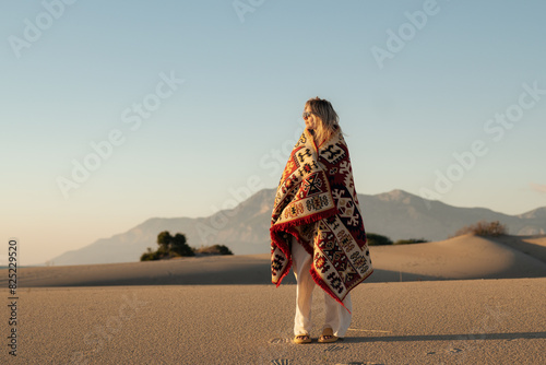 Anonymous woman standing with blanket on shoulders photo