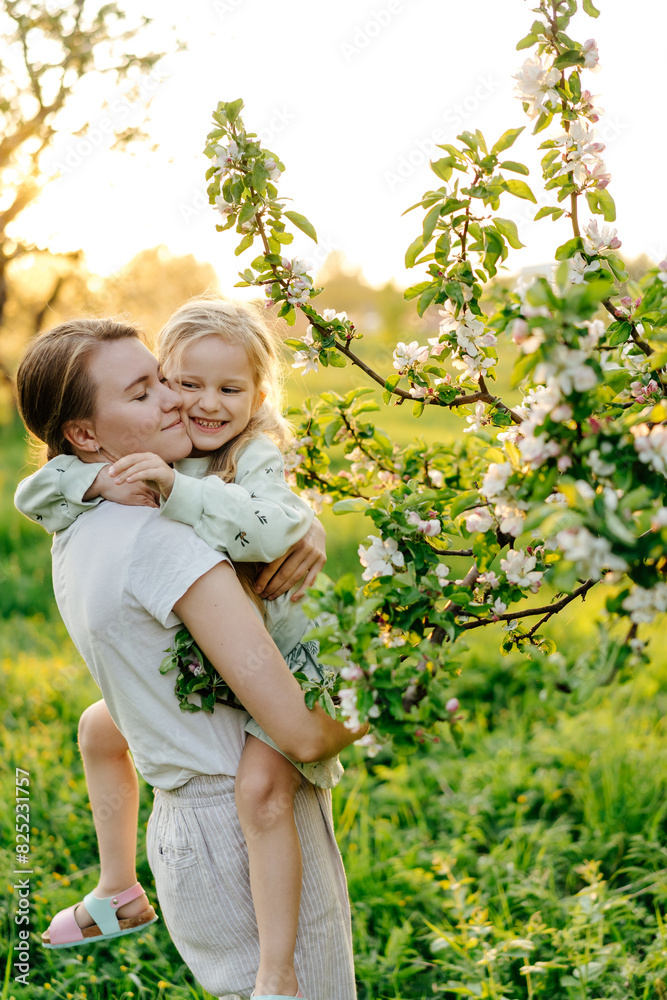 Child with mother near blossom apple tree Child with mother near blossom apple tree