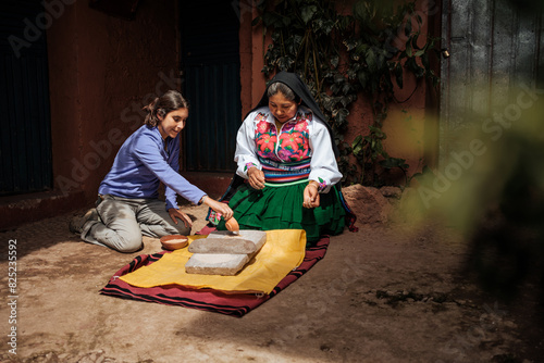 Tourist learning ancestral techniques from an indigenous woman photo