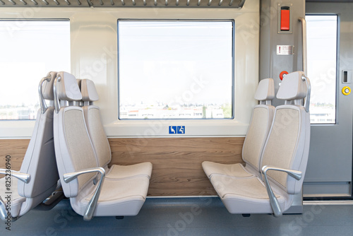 Seats reserved for use by pregnant or disabled persons on a train photo