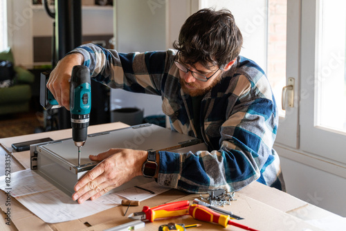 Man assemble furniture at new home photo