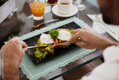 Enjoying a healthy avocado toast breakfast with poached eggs