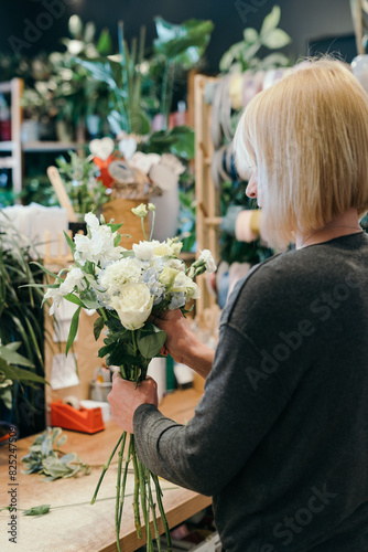 Florist at work in a flower shop photo