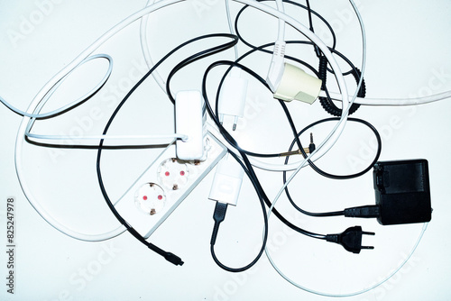 Wires, chargers and cords on a business office floor with flashlight photo
