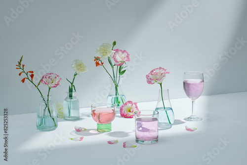 Beautiful summer and spring flowers in different size glass vases