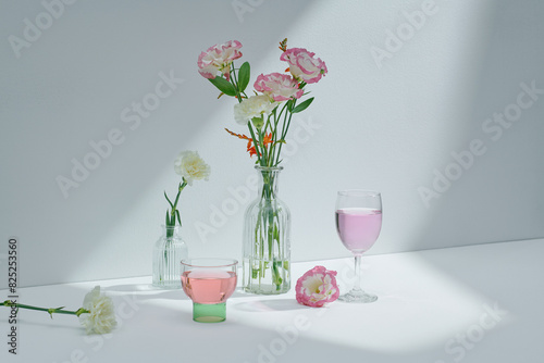 Front view of flower stems arranged in glass vases photo