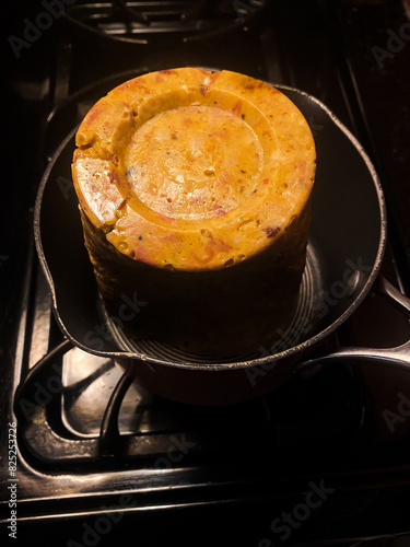Leftover soup in a pot on a stovetop burner. photo